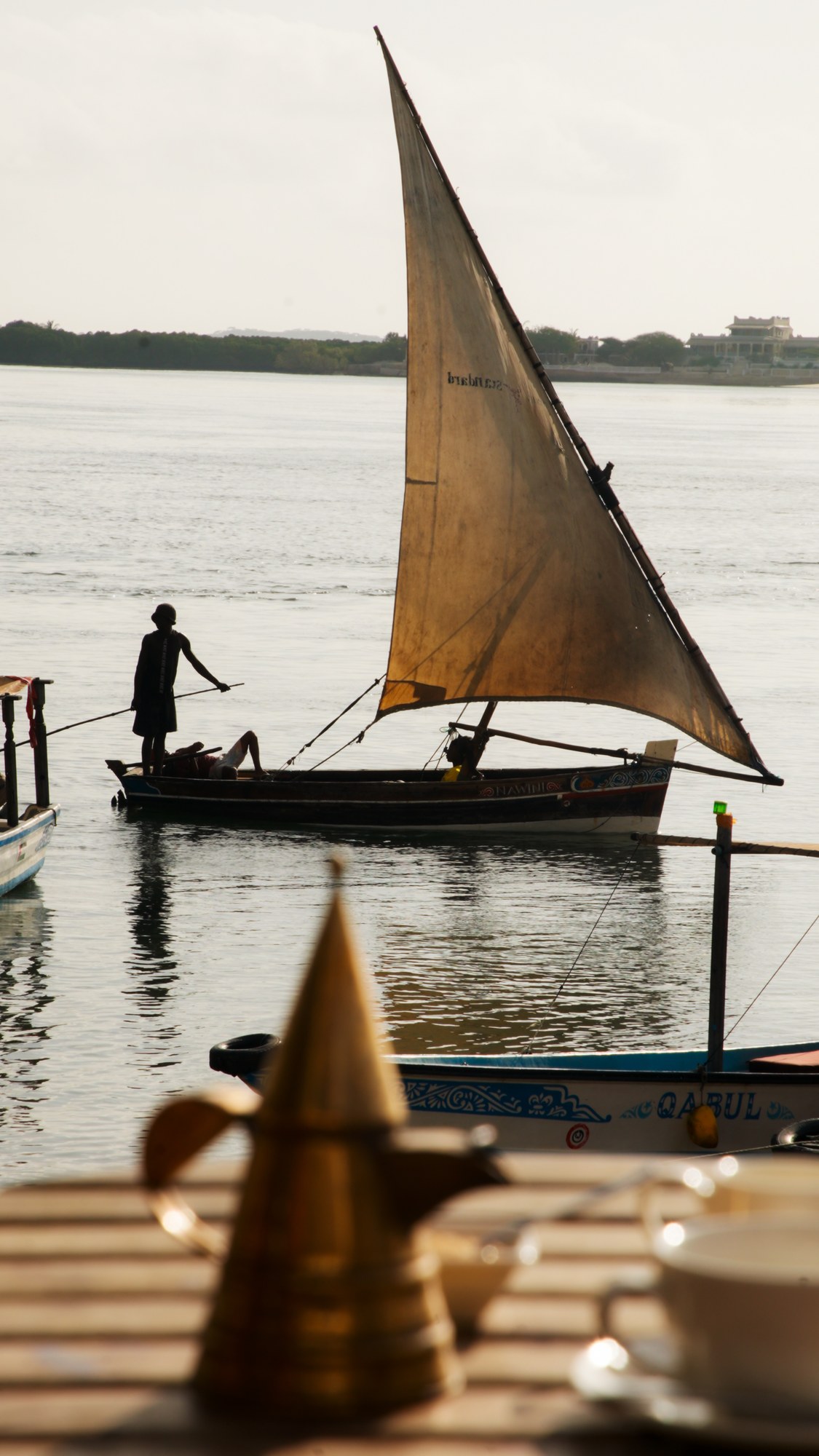 Dhow sail against the channel